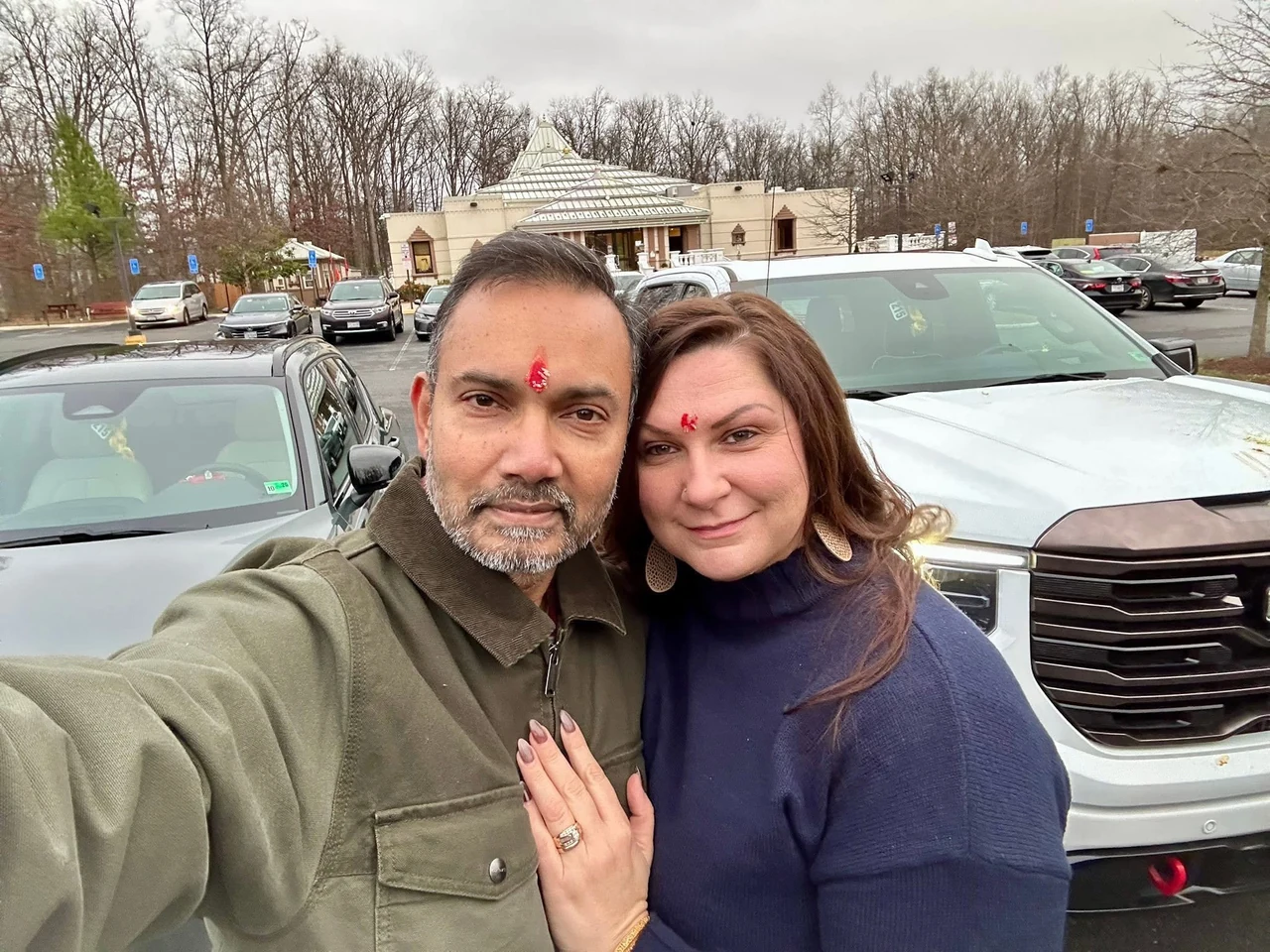 Amy and Srinu standing close together outdoors
