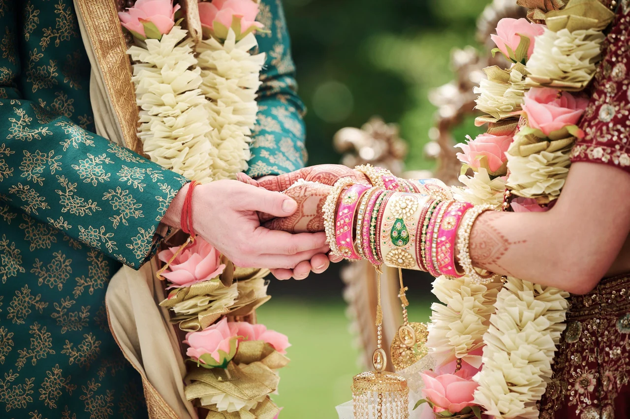 Anchal and Arin holding hands during their wedding ceremony at Salamander Resort.
