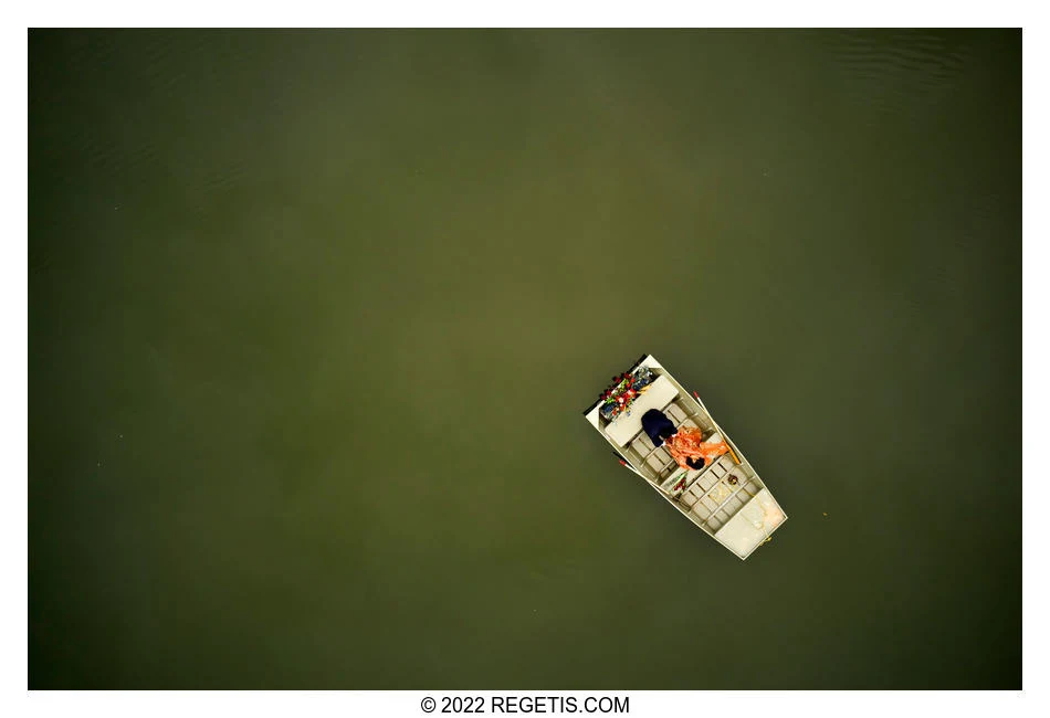 Anjali and Chris together in a flower-adorned boat on the lake at Crockett Park, photographed from directly overhead by The Regeti’s