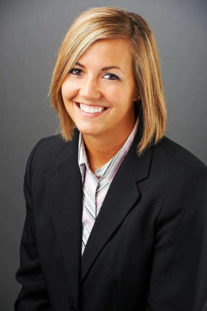 A smiling real-estate professional in a black jacket, photographed by The Regeti’s