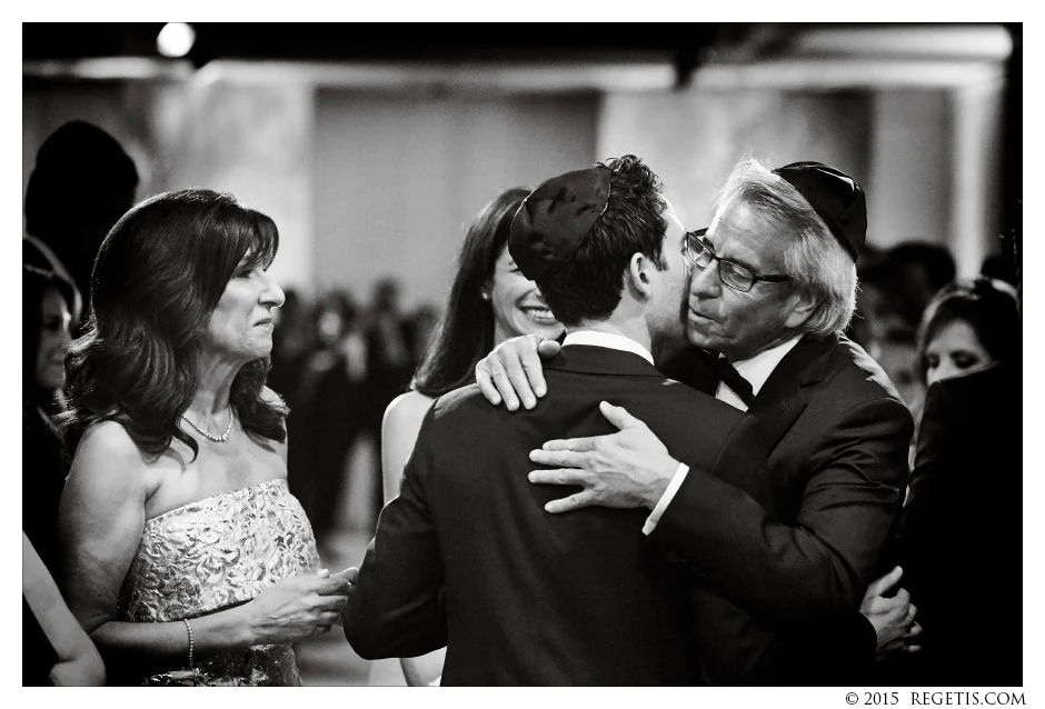 A warm embrace during Stephanie and Erik’s wedding ceremony, with loved ones gathered close