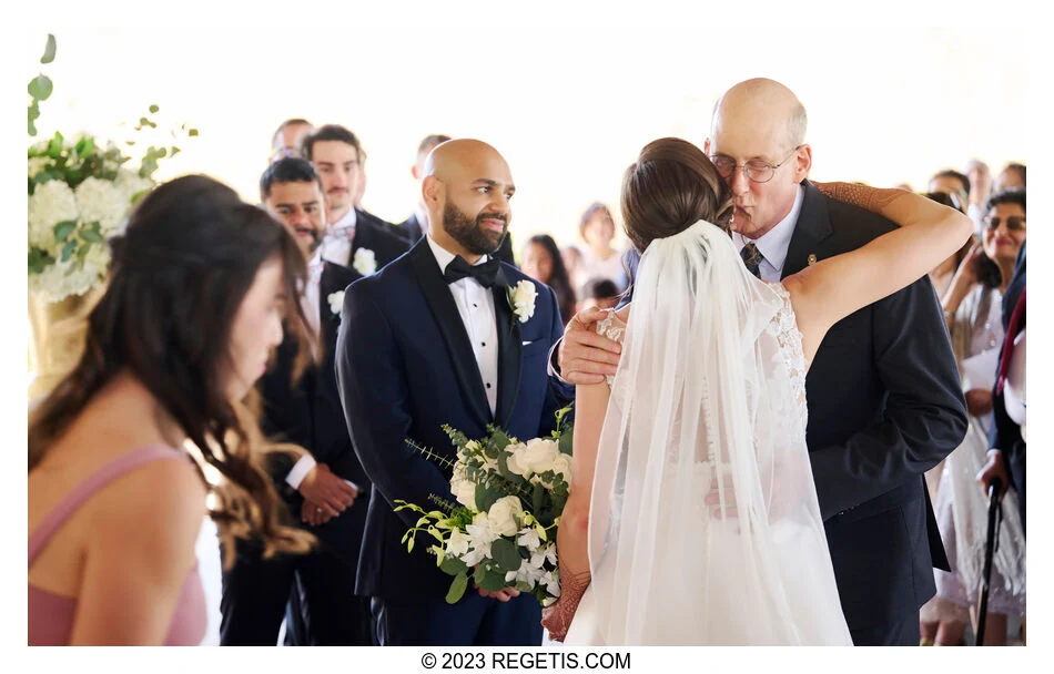 Julia embraces a loved one during the ceremony at Hyatt Regency Chesapeake Bay, with Tarak beside her.