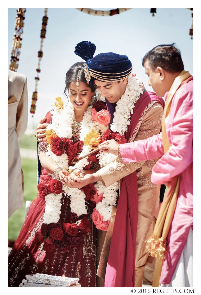 Kavita and Amit sharing an offering during their wedding ceremony