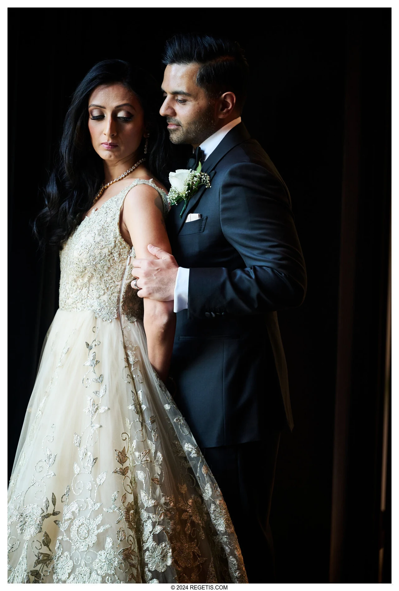 Leena and Anup in a softly lit formal portrait in their reception attire.
