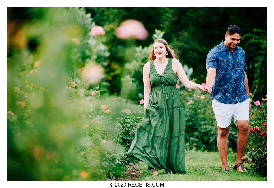 Payton and Sanket holding hands among the roses at Bon Air Rose Garden