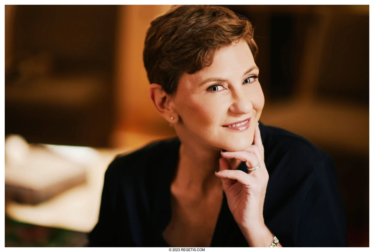 Kirsten in a relaxed professional portrait with a warmly lit office background, photographed by The Regeti’s