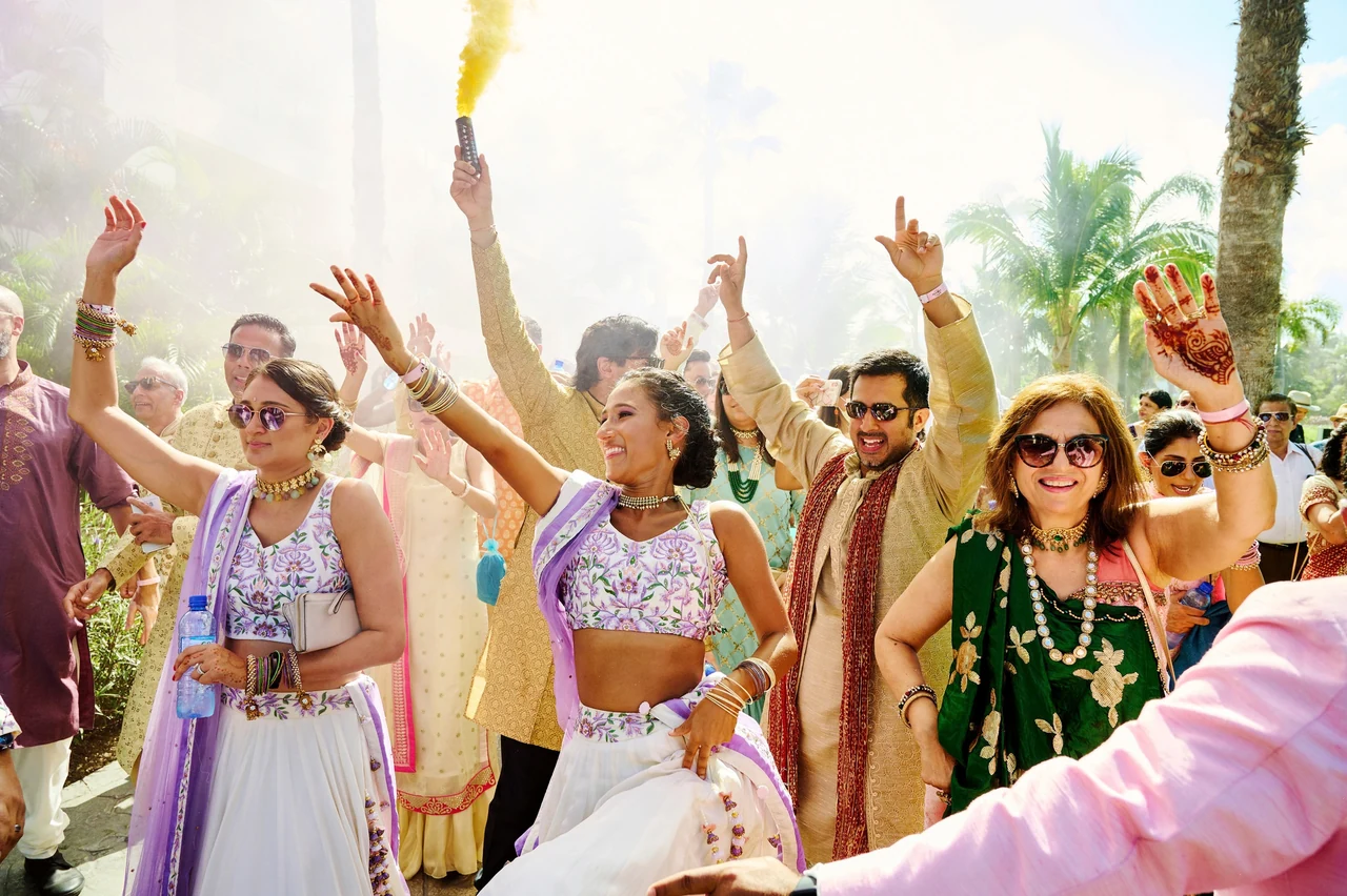 Wedding guests and the groom celebrating together outdoors