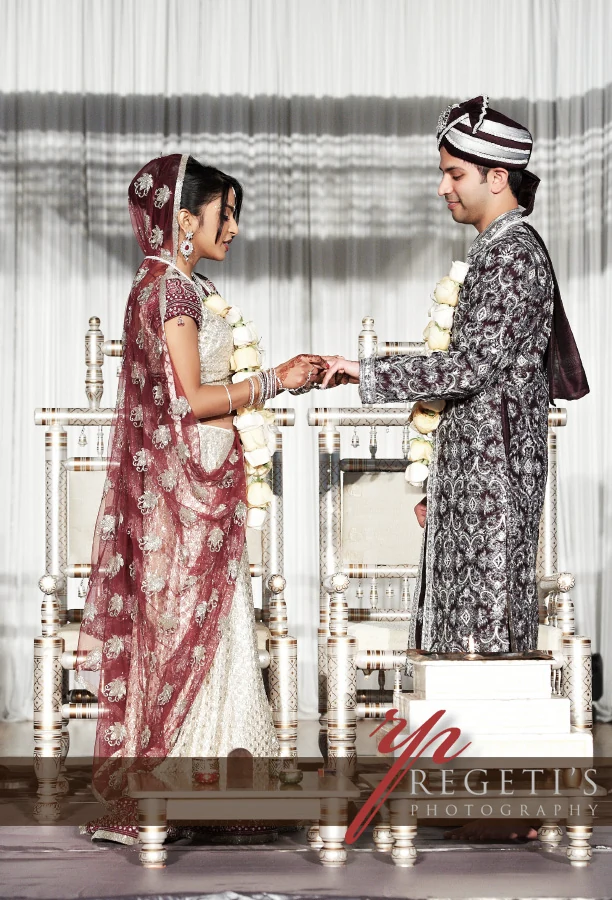 Rupa and Viral holding hands during their wedding ceremony