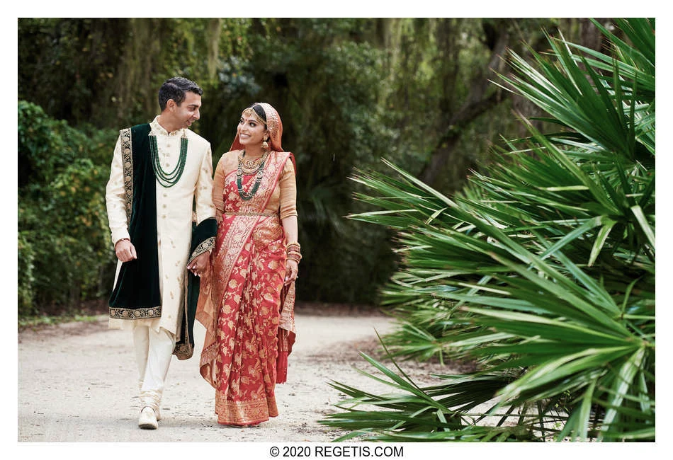Shruthi and Arjun walking together among the palms on Amelia Island, Florida, before their Hindu wedding.
