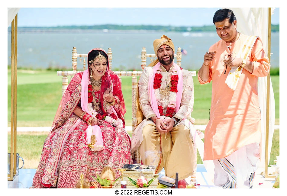 Simran and Komal laughing during their wedding ceremony beside Chesapeake Bay.