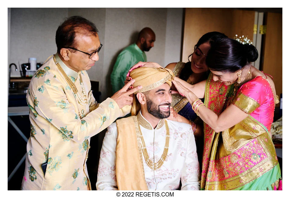 Loved ones help the groom with his turban before Simran and Komal’s wedding