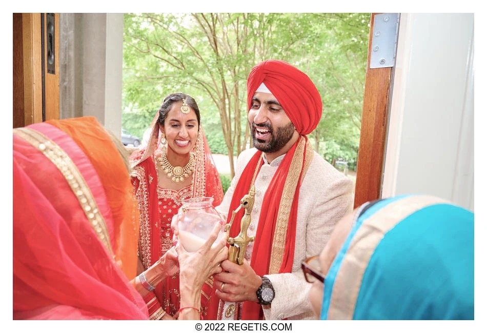 Sukhi and Jaskaran sharing a joyful doorway moment during their wedding celebrations at The Ballantyne in Charlotte, North Carolina.